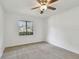 Bright bedroom featuring a window, carpet, ceiling fan, and neutral wall color at 4221 Meadowbend Ct, Lakeland, FL 33811