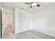 This bedroom features neutral carpet, a ceiling fan, and a closet for storage at 4221 Meadowbend Ct, Lakeland, FL 33811