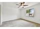 Bright bedroom with neutral carpet, ceiling fan, and a window view of the pool at 4221 Meadowbend Ct, Lakeland, FL 33811