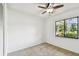 Well-lit bedroom with neutral carpet and large window for natural light at 4221 Meadowbend Ct, Lakeland, FL 33811