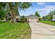Traditional single-story home with an attached two-car garage and long driveway at 4221 Meadowbend Ct, Lakeland, FL 33811
