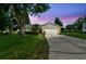 Well-maintained home with a two-car garage and a spacious driveway at dusk at 4221 Meadowbend Ct, Lakeland, FL 33811