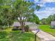 Charming home featuring a lush front lawn, mature trees, and a basketball hoop on the driveway at 4221 Meadowbend Ct, Lakeland, FL 33811