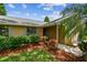 Charming single-story home with a brick exterior and beautifully landscaped front yard at 4221 Meadowbend Ct, Lakeland, FL 33811