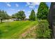 The expansive front lawn enhances the property's curb appeal with lush greenery and mature trees at 4221 Meadowbend Ct, Lakeland, FL 33811