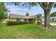 Charming single-story brick home with mature landscaping and a well-maintained front lawn at 4221 Meadowbend Ct, Lakeland, FL 33811