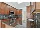Kitchen with dark wood cabinets, granite countertops and stainless steel appliances at 4221 Meadowbend Ct, Lakeland, FL 33811