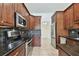 Modern kitchen featuring granite countertops, stainless steel appliances, and dark wood cabinets at 4221 Meadowbend Ct, Lakeland, FL 33811