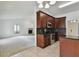 Open-concept kitchen with dark wood cabinets and modern appliances overlooking the living area at 4221 Meadowbend Ct, Lakeland, FL 33811