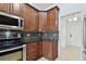 Kitchen with dark wood cabinetry, stainless steel appliances, and tile backsplash at 4221 Meadowbend Ct, Lakeland, FL 33811