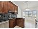 Well-lit kitchen features dark wood cabinetry, modern appliances, and an adjacent eat-in breakfast nook at 4221 Meadowbend Ct, Lakeland, FL 33811