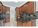 Well-equipped kitchen with stainless steel appliances, dark countertops, and tile flooring at 4221 Meadowbend Ct, Lakeland, FL 33811