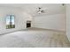Large living room with a fireplace, ceiling fan, and bright window at 4221 Meadowbend Ct, Lakeland, FL 33811