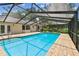 Covered outdoor pool featuring a brick patio and refreshing blue water at 4221 Meadowbend Ct, Lakeland, FL 33811