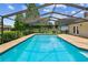 The pool features a screened enclosure and brick border, seamlessly blending indoor and outdoor living at 4221 Meadowbend Ct, Lakeland, FL 33811