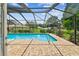 Relax by the sparkling pool inside a screened enclosure with brick paver decking at 4221 Meadowbend Ct, Lakeland, FL 33811