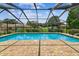 Relax by the sparkling pool inside a screened enclosure and brick paver decking at 4221 Meadowbend Ct, Lakeland, FL 33811