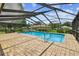 Enjoy this sparkling pool inside a screened enclosure with brick paver decking at 4221 Meadowbend Ct, Lakeland, FL 33811