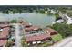 Aerial view of lakeside condos, a parking lot, and surrounding foliage at 1920 E Edgewood Dr # E1, Lakeland, FL 33803