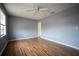 Spacious bedroom featuring hardwood floors, two windows, and neutral paint at 1920 E Edgewood Dr # E1, Lakeland, FL 33803