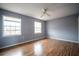 Empty bedroom with hardwood floors, blue walls, and bright natural light at 1920 E Edgewood Dr # E1, Lakeland, FL 33803