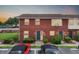 Two-story brick townhouse with lush landscaping and parking spaces in front at 1920 E Edgewood Dr # E1, Lakeland, FL 33803