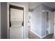 Convenient stacked washer and dryer laundry area in a bright hallway at 1920 E Edgewood Dr # E1, Lakeland, FL 33803
