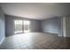 Bright living room with tile flooring and a sliding glass door to the outside at 1920 E Edgewood Dr # E1, Lakeland, FL 33803