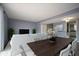Staged living room with hardwood table, a large sofa, and light-blue walls at 1920 E Edgewood Dr # E1, Lakeland, FL 33803