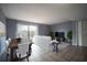 Staged living room with tile floors, a dining table, and a sliding glass door at 1920 E Edgewood Dr # E1, Lakeland, FL 33803