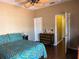 Bedroom featuring a patterned quilt, ceiling fan, and neutral color scheme at 314 Lake Butler Dr, Kissimmee, FL 34759