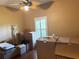 Bedroom with window shutter, hardwood floors, and a ceiling fan at 314 Lake Butler Dr, Kissimmee, FL 34759