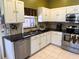 Kitchen featuring granite countertops, stainless steel appliances, and custom cabinets at 314 Lake Butler Dr, Kissimmee, FL 34759