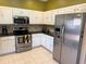 Well-lit kitchen with stainless steel appliances and granite countertops at 314 Lake Butler Dr, Kissimmee, FL 34759