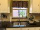 Stainless steel kitchen sink featuring a window and granite countertops at 314 Lake Butler Dr, Kissimmee, FL 34759