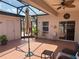 Enclosed lanai with brick floors, ceiling fan, and outdoor seating area is perfect for relaxing and enjoying the outdoors at 314 Lake Butler Dr, Kissimmee, FL 34759
