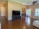 Bright living room featuring wood floors, ceiling fan, and an open layout at 314 Lake Butler Dr, Kissimmee, FL 34759