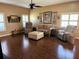 Spacious living room with hardwood floors, natural light, and neutral decor at 314 Lake Butler Dr, Kissimmee, FL 34759