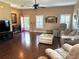Open living area with laminate flooring, furniture, and large windows at 314 Lake Butler Dr, Kissimmee, FL 34759