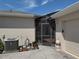 Exterior shot of house with a screened-in patio area and garage at 314 Lake Butler Dr, Kissimmee, FL 34759