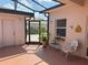 Covered outdoor patio featuring red brick pavers and a screened-in entrance at 314 Lake Butler Dr, Kissimmee, FL 34759