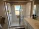 Shower area with glass enclosure, window, shower seat, and tile surround at 314 Lake Butler Dr, Kissimmee, FL 34759