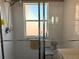 Shower with a window, glass doors, handrails, and a shower seat at 314 Lake Butler Dr, Kissimmee, FL 34759