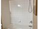 Bathtub featuring white tile and a shower head at 314 Lake Butler Dr, Kissimmee, FL 34759