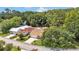 Aerial view of a single-Gathering home with a brown roof surrounded by lush greenery at 454 San Jose Dr, Winter Haven, FL 33884