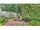 Charming backyard patio with mature greenery, providing a serene outdoor seating area at 454 San Jose Dr, Winter Haven, FL 33884