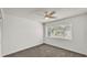 Bedroom with neutral carpet, ceiling fan, and window overlooking trees at 454 San Jose Dr, Winter Haven, FL 33884