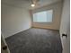 Neutral bedroom featuring a ceiling fan, new carpet, and a bright window at 454 San Jose Dr, Winter Haven, FL 33884