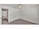 A bright bedroom features neutral carpet and a ceiling fan, along with a closet and an open doorway at 454 San Jose Dr, Winter Haven, FL 33884