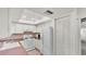 Charming kitchen with white cabinets, tiled backsplash, and skylight at 454 San Jose Dr, Winter Haven, FL 33884